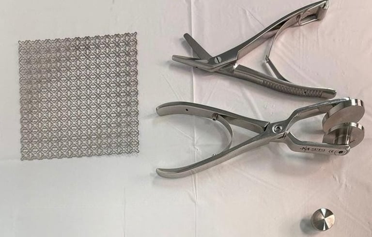 Metal hole punch tool and textured aluminum sheet on white surface